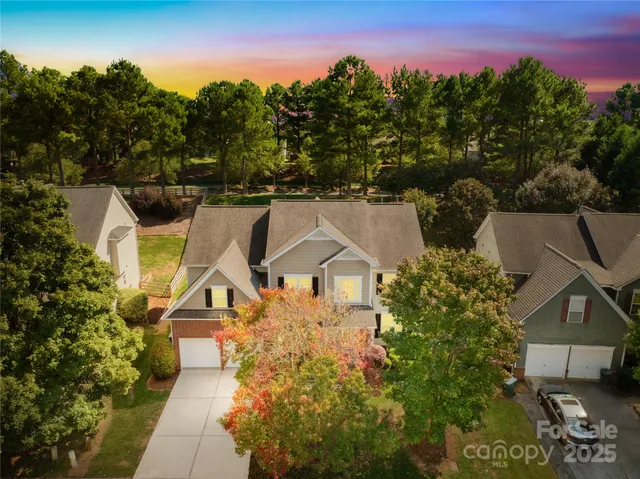 an aerial view of a house with a garden and a yard