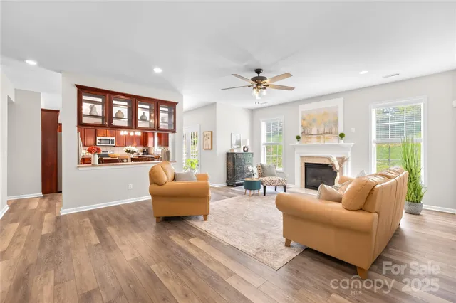 a living room with furniture a window and a fireplace