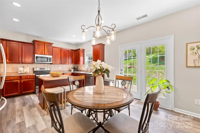 a kitchen with stainless steel appliances granite countertop a refrigerator stove microwave sink and cabinets