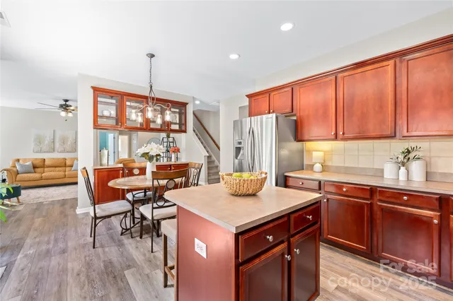 a kitchen with a sink a stove and wooden cabinets