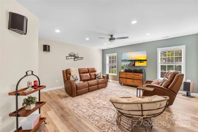 a living room with furniture a rug and a window