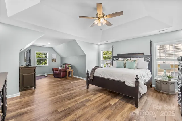 a bedroom with a bed and a mirror on the dresser