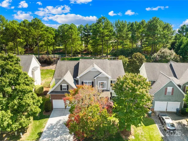 a house is sitting in middle of the garden