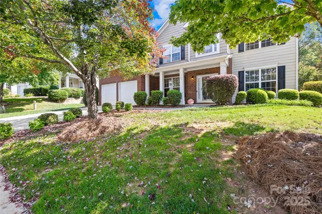 a view of a house with a yard and garden