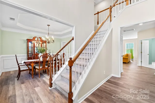a view of an entryway with wooden floor and stairs