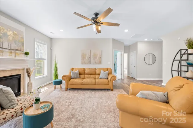 a living room with furniture and a fireplace