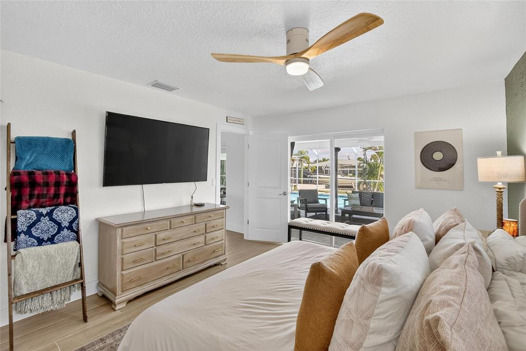 6337 Cocoa Lane Apollo Beach, FL 33572 - Photo 16 of 39 a bedroom with a bed and a flat screen tv