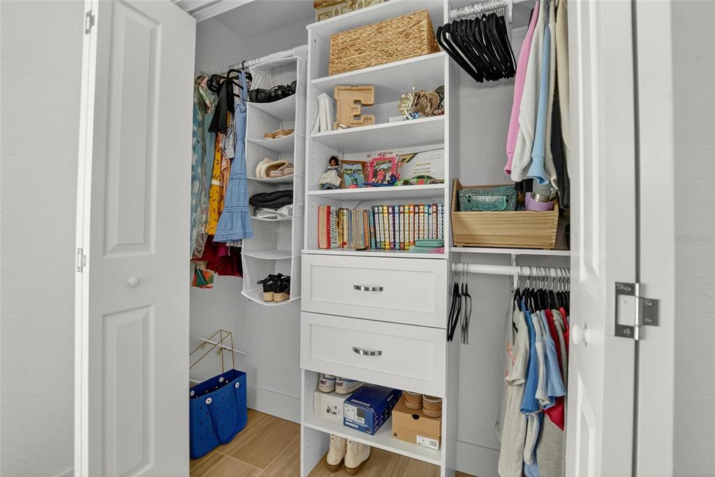 6337 Cocoa Lane Apollo Beach, FL 33572 - Photo 21 of 39 a view of walk in closet with clothes and shoes