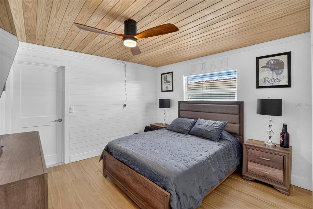 6337 Cocoa Lane Apollo Beach, FL 33572 - Photo 22 of 39 a bedroom with a bed and a flat tv screen on dresser