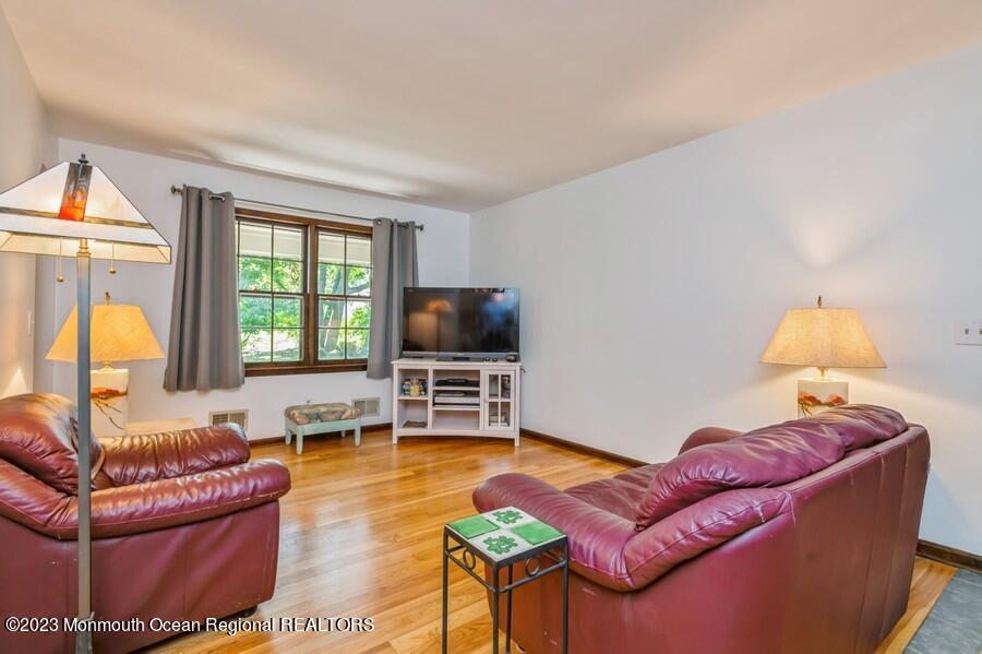 1711 Glendola Road Wall, NJ 07719 - Photo 14 of 25 a living room with furniture and a flat screen tv