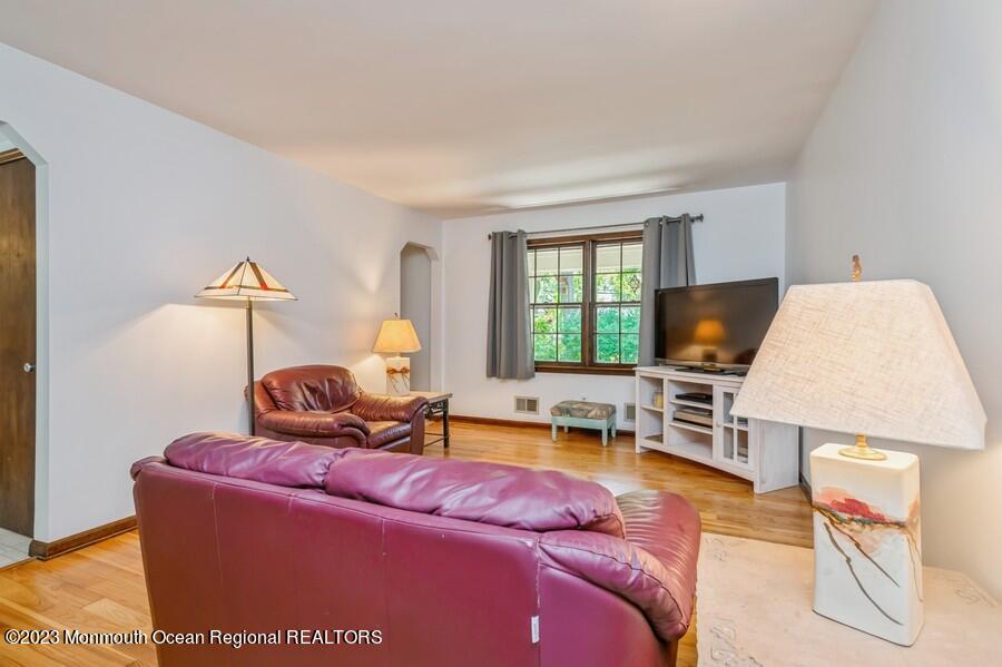 1711 Glendola Road Wall, NJ 07719 - Photo 15 of 25 a living room with furniture a window and a flat screen tv