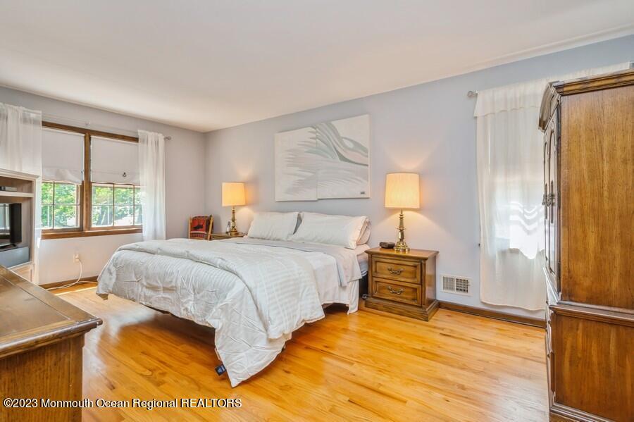 1711 Glendola Road Wall, NJ 07719 - Photo 16 of 25 a bedroom with a bed and wooden floor