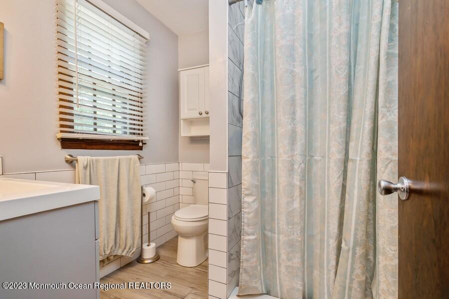 1711 Glendola Road Wall, NJ 07719 - Photo 17 of 25 a bathroom with a toilet a sink and a window