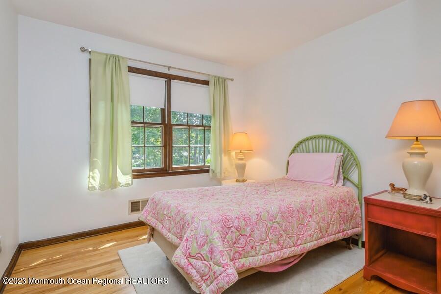 1711 Glendola Road Wall, NJ 07719 - Photo 18 of 25 a bedroom with a bed lamp and a window