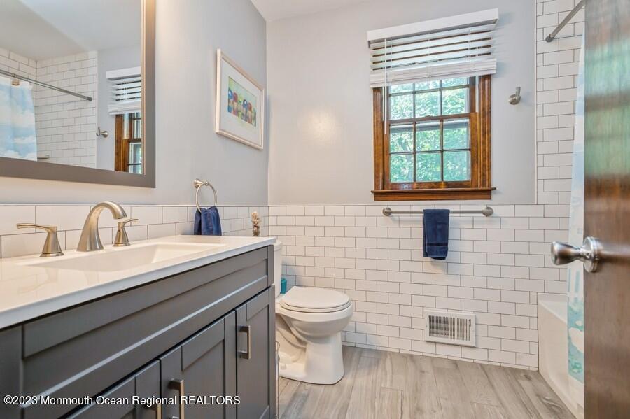 1711 Glendola Road Wall, NJ 07719 - Photo 21 of 25 a bathroom with a sink a toilet and a window