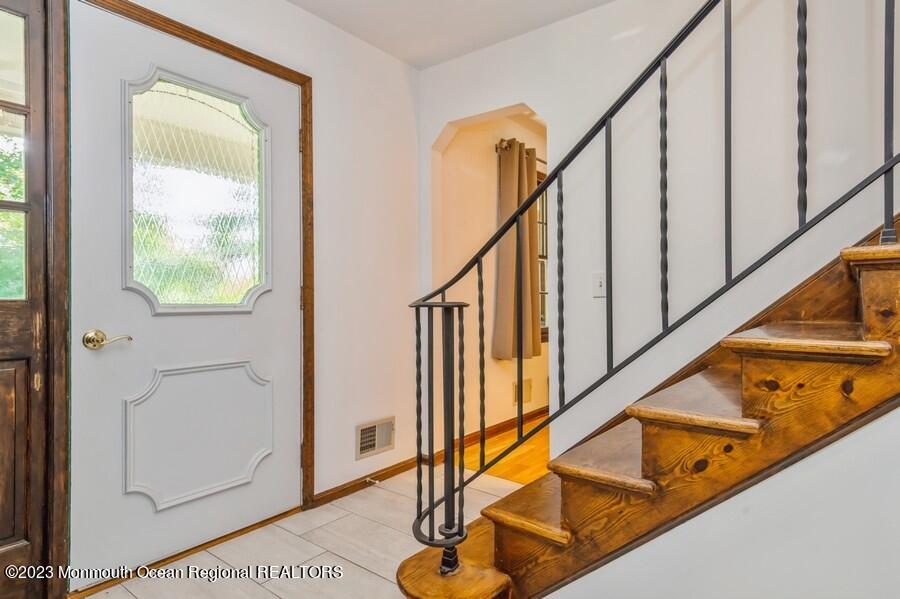 1711 Glendola Road Wall, NJ 07719 - Photo 3 of 25 a view of staircase with white walls and black white walls