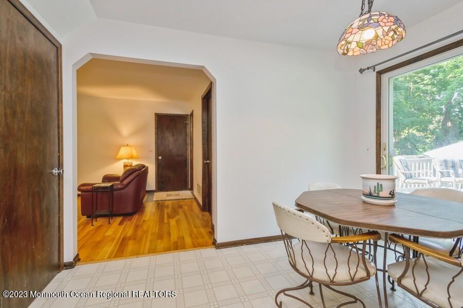 1711 Glendola Road Wall, NJ 07719 - Photo 10 of 25 a view of a dining room with furniture a chandelier and wooden floor
