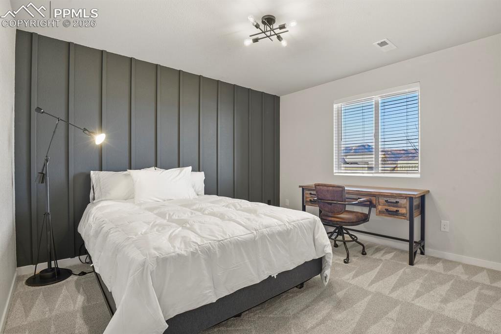 11314 Modern Meadow Loop Colorado Springs, CO 80921 - Photo 22 of 30 a bedroom with a bed and a window
