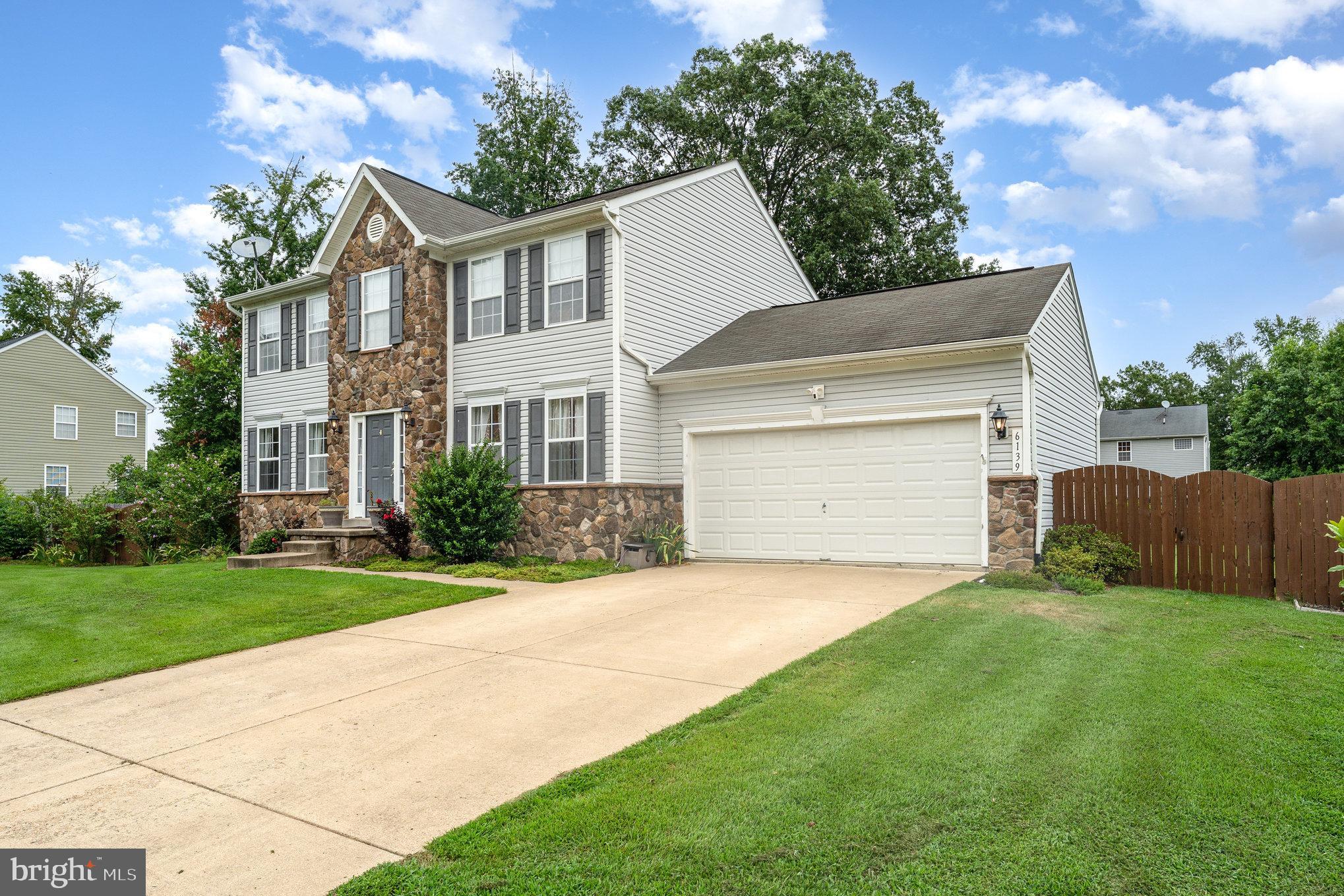 6139 Schooner Circle King George, VA 22485 - Photo 2 of 29 a front view of a house with a yard and garage