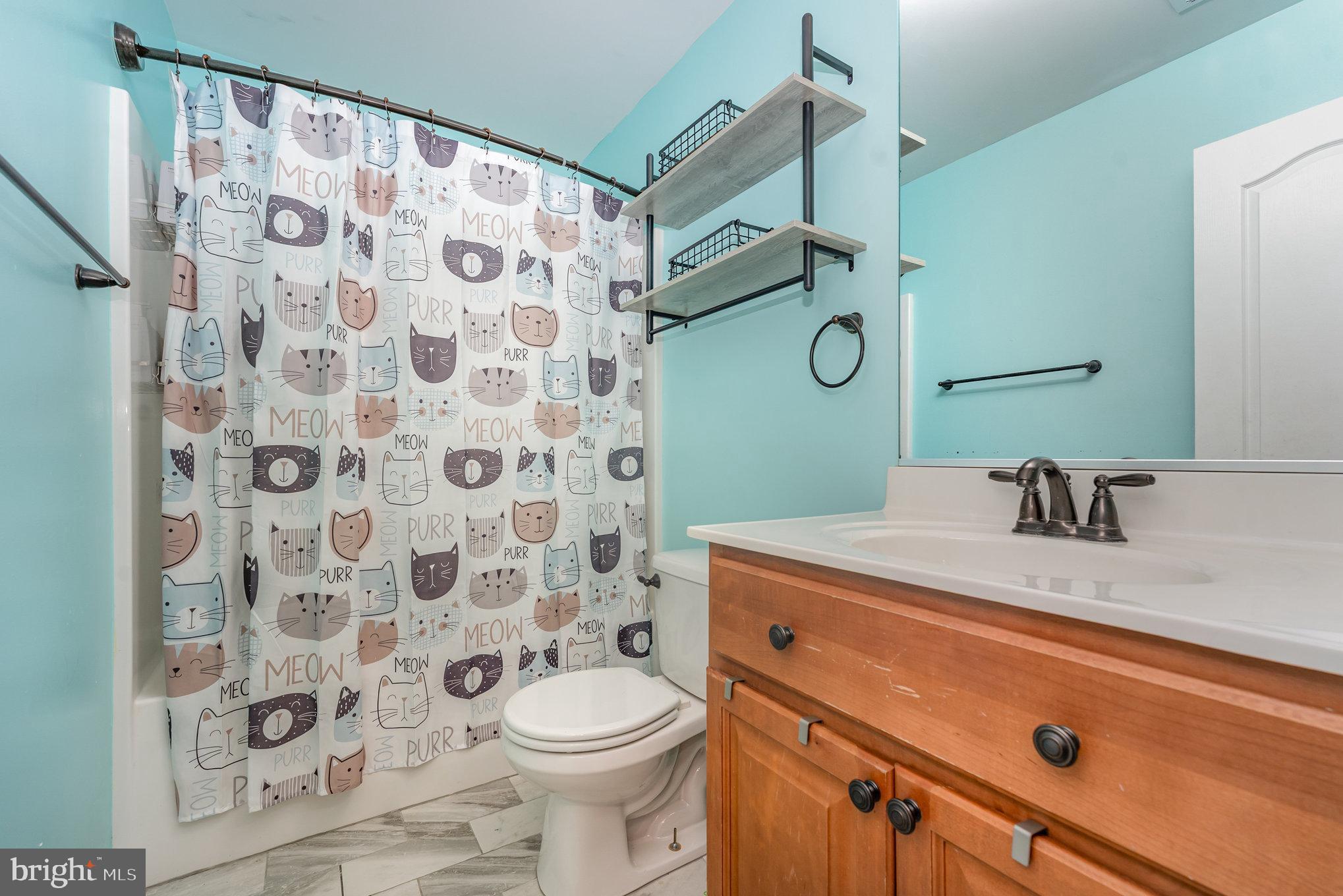 6139 Schooner Circle King George, VA 22485 - Photo 21 of 29 a bathroom with a granite countertop sink a toilet and a mirror