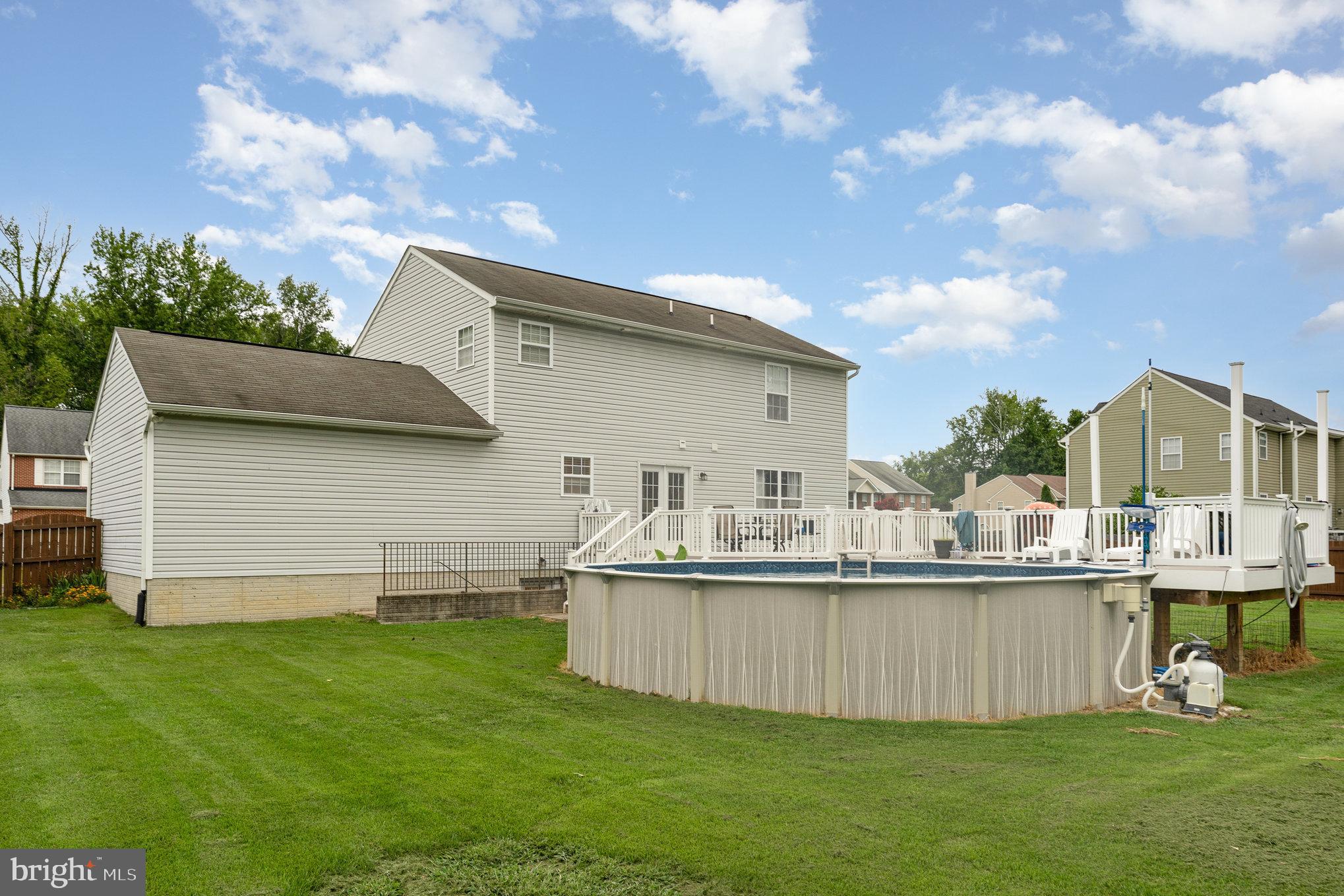 6139 Schooner Circle King George, VA 22485 - Photo 4 of 29 a view of a house with a backyard and pool