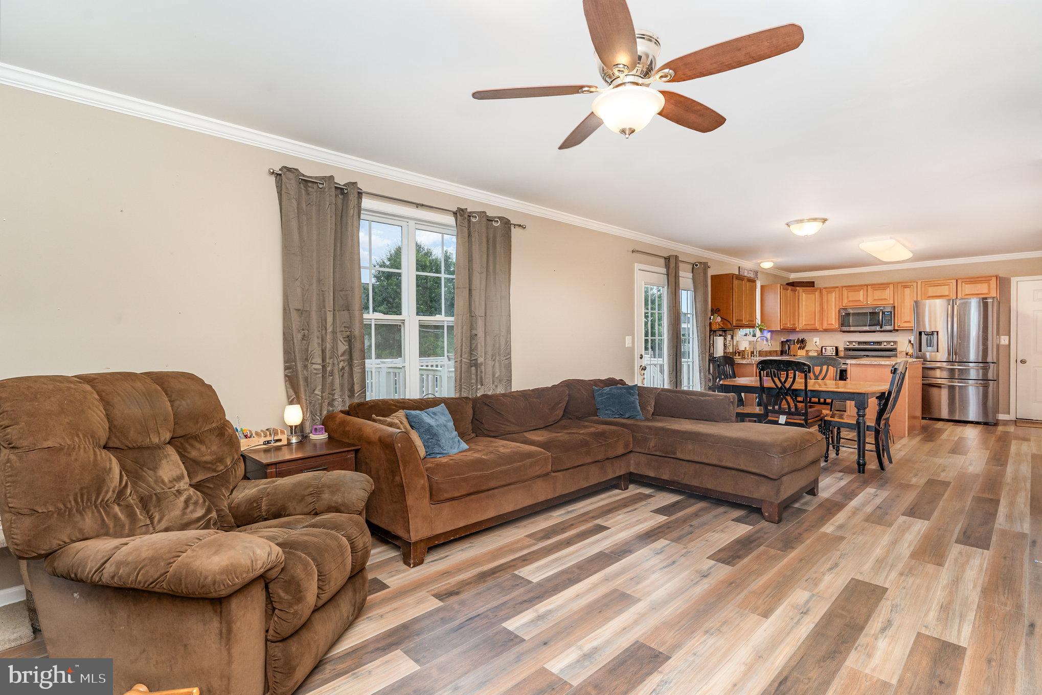 6139 Schooner Circle King George, VA 22485 - Photo 8 of 29 a living room with furniture and a large window