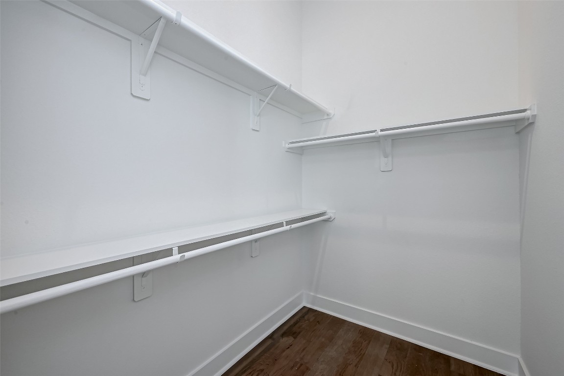6032 Beall Street Houston, TX 77091 - Photo 17 of 26 Ample storage space awaits in this generous walk-in closet. Dual-height hanging rods and shelving keep everything organized, while crisp white finishes reflect the home’s modern style.