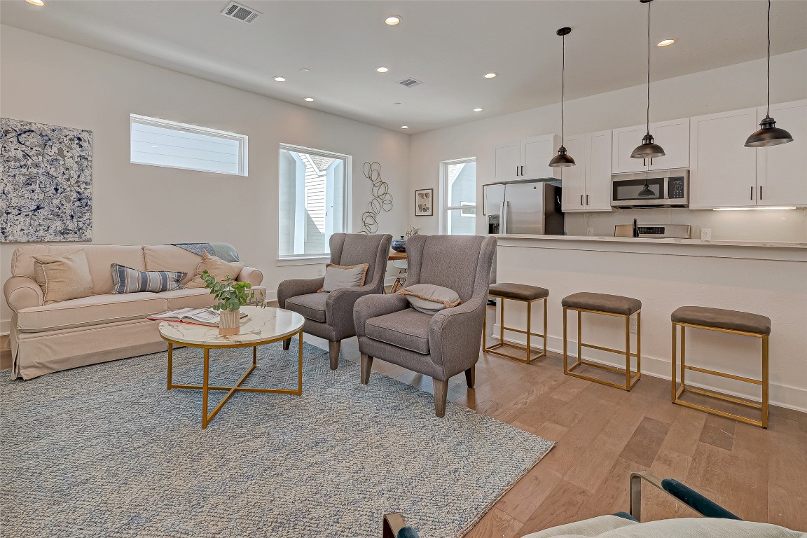 6032 Beall Street Houston, TX 77091 - Photo 3 of 26 Another angle on the main living area highlights abundant natural light and flexible space for art, media, and lounging. A perfect balance of modern elegance and inviting comfort for daily living.