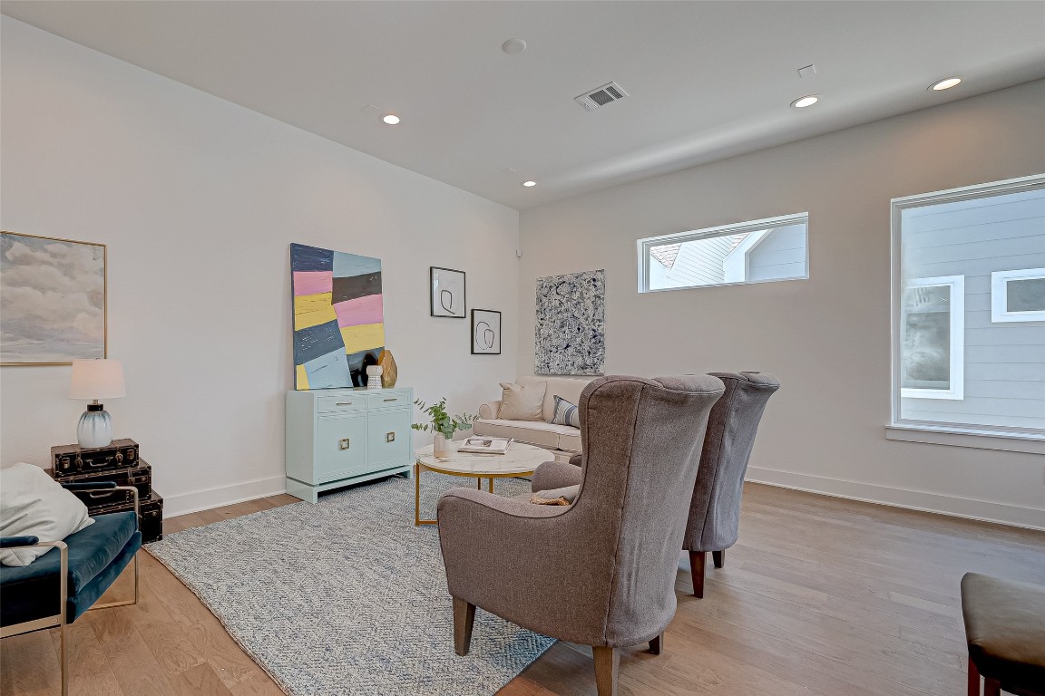 6032 Beall Street Houston, TX 77091 - Photo 4 of 26 Bright and welcoming, this living space features high ceilings, recessed lighting, and wide wood flooring. The sleek layout and natural light create the perfect backdrop for relaxing or entertaining.