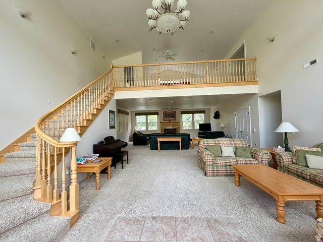 1133 Paris Canyon Road Paris, ID 83261 - Photo 9 of 75 Grand entryway featuring a curved staircase with natural wood railing opening up to three living room areas