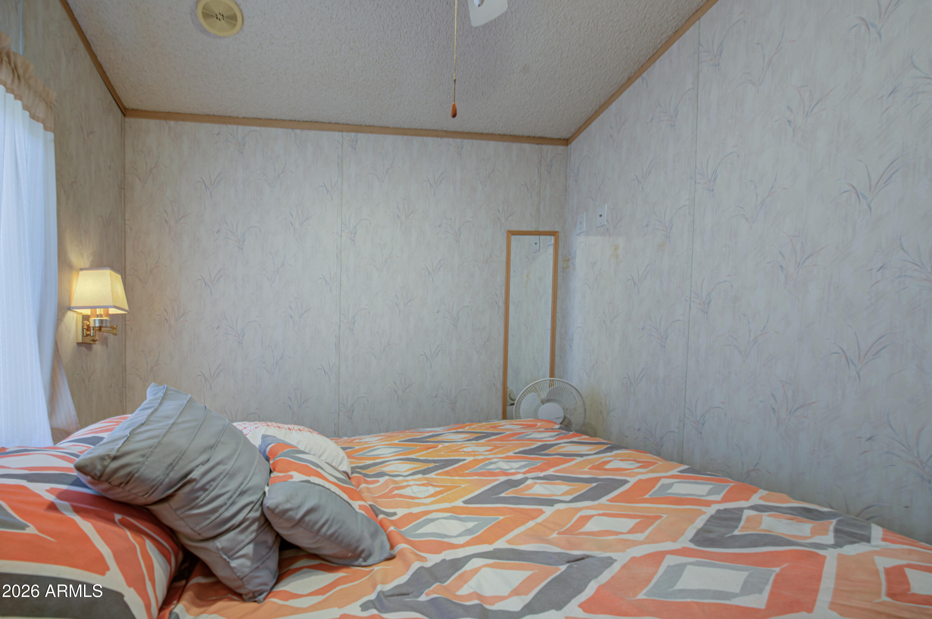 7750 East Broadway Road, Unit 273 Mesa, AZ 85208 - Photo 14 of 36 a bedroom with a bed and a lamp