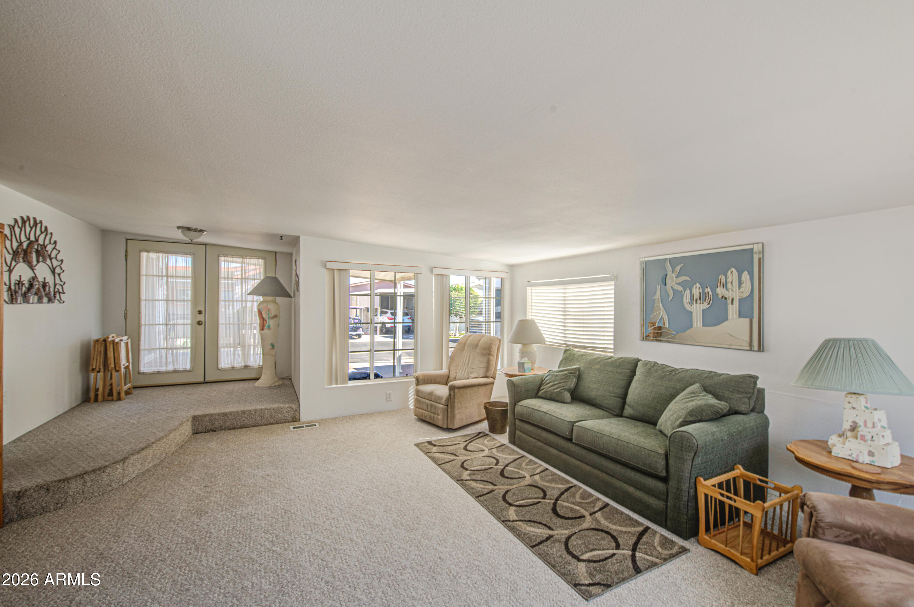 7750 East Broadway Road, Unit 273 Mesa, AZ 85208 - Photo 18 of 36 a living room with furniture and large windows