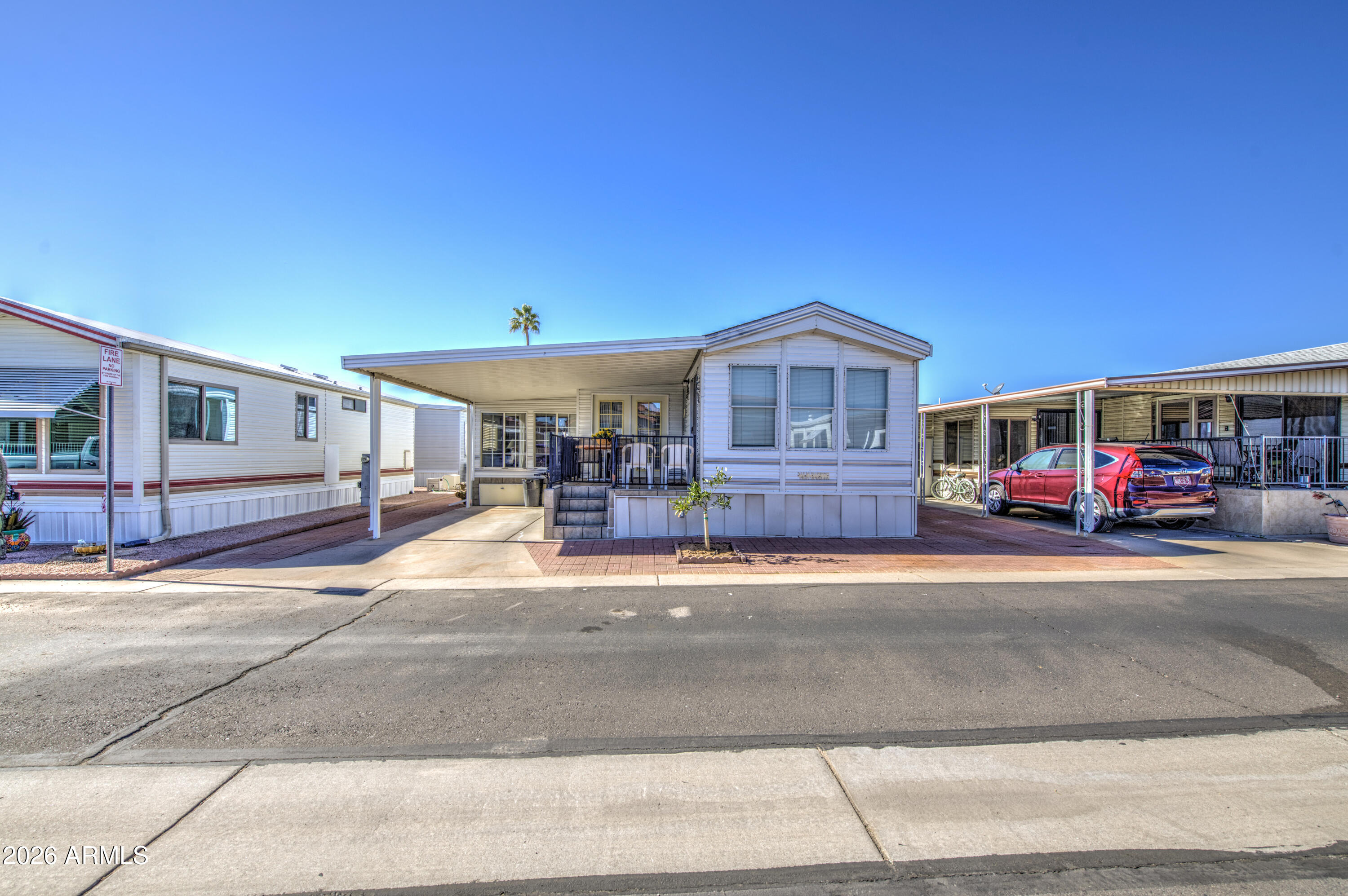 7750 East Broadway Road, Unit 273 Mesa, AZ 85208 - Photo 20 of 36 a front view of a house with a garden