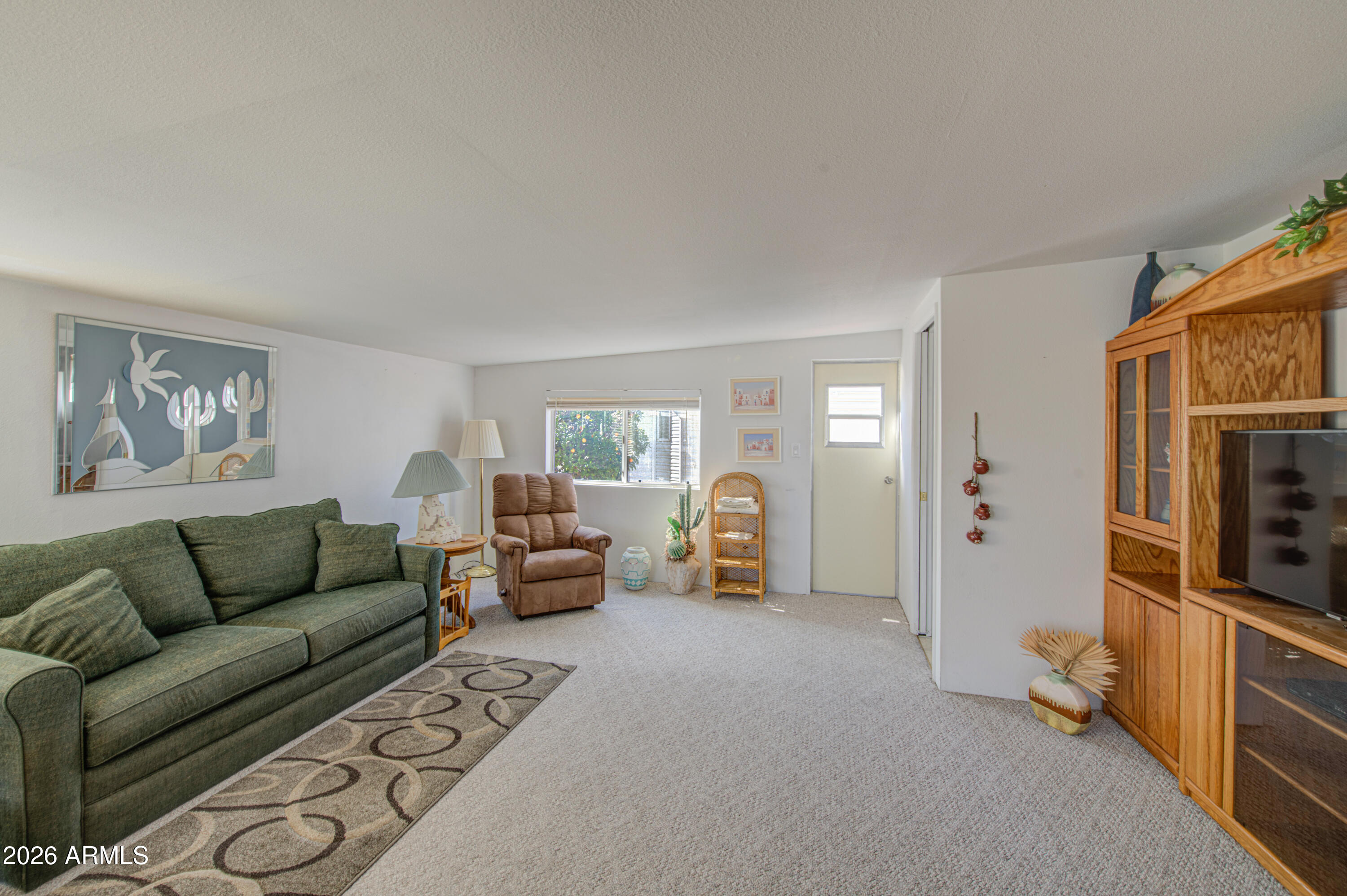 7750 East Broadway Road, Unit 273 Mesa, AZ 85208 - Photo 3 of 36 a living room with furniture and a flat screen tv