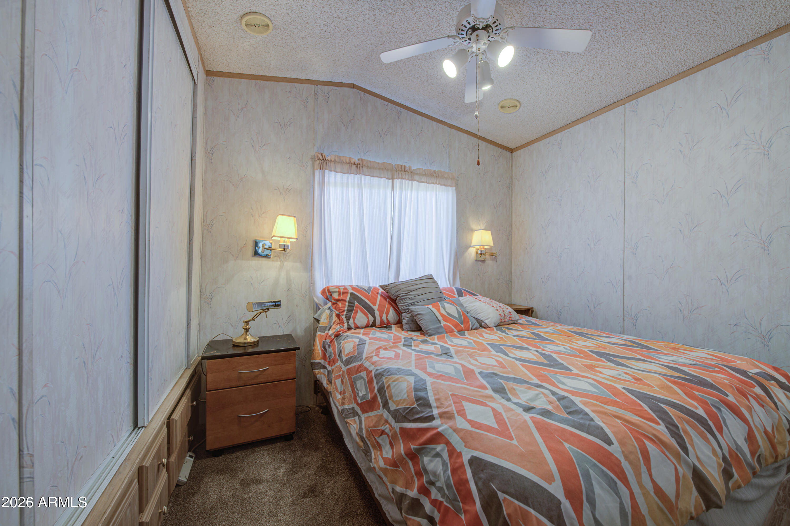 7750 East Broadway Road, Unit 273 Mesa, AZ 85208 - Photo 4 of 36 a bedroom with a bed and a chandelier