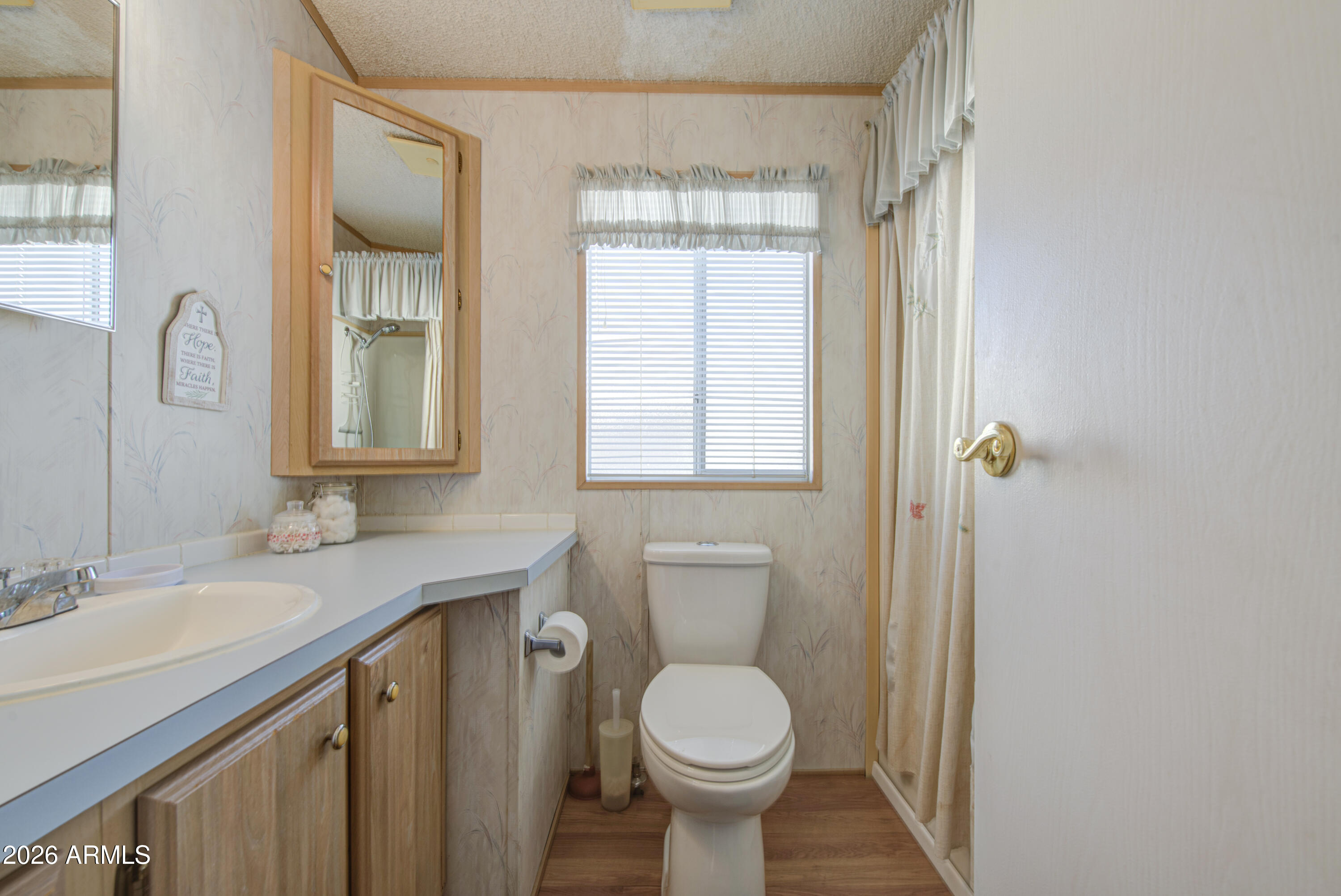 7750 East Broadway Road, Unit 273 Mesa, AZ 85208 - Photo 5 of 36 a bathroom with a granite countertop sink toilet and a mirror