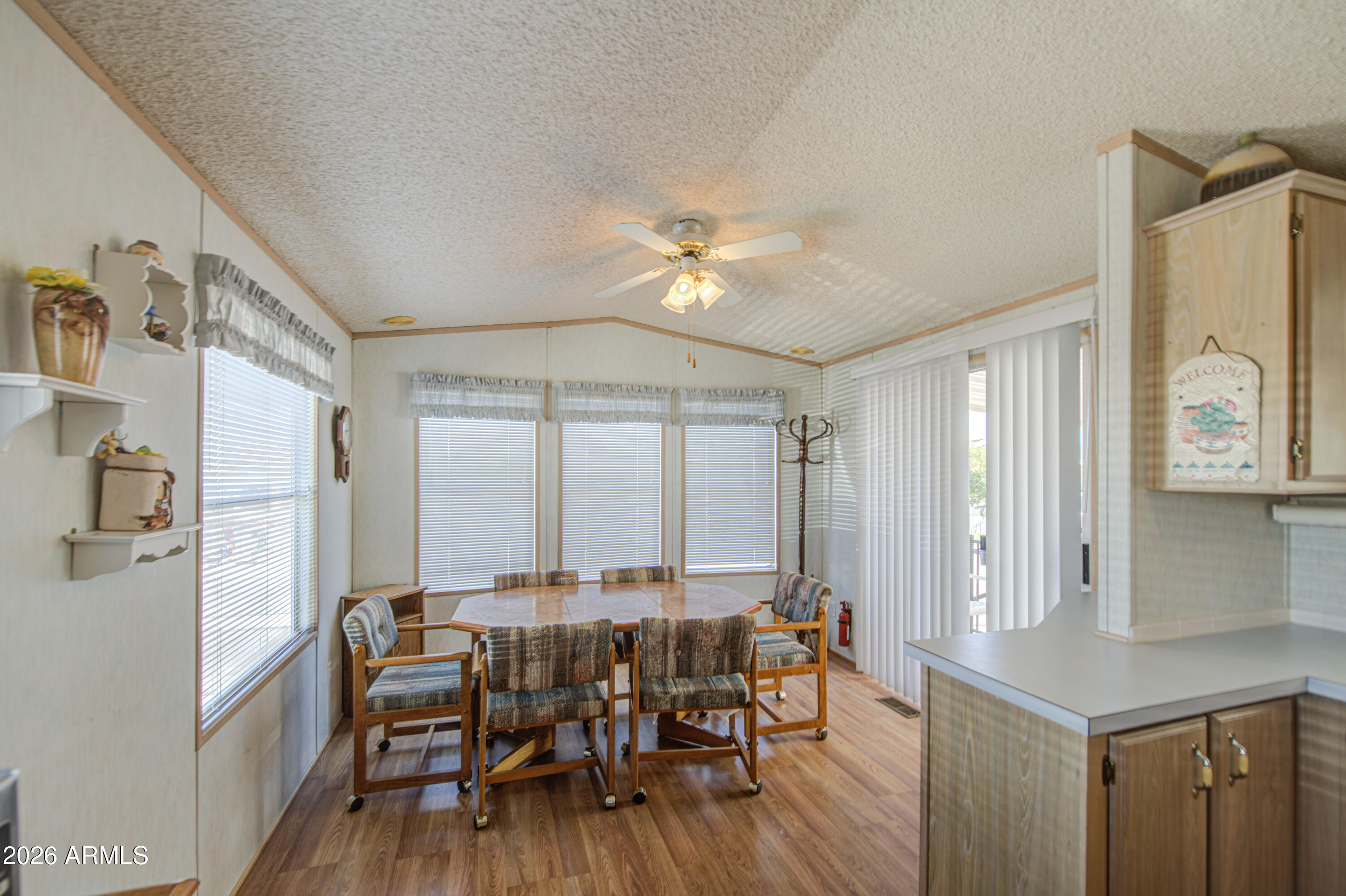 7750 East Broadway Road, Unit 273 Mesa, AZ 85208 - Photo 8 of 36 a dining room with furniture and wooden floor