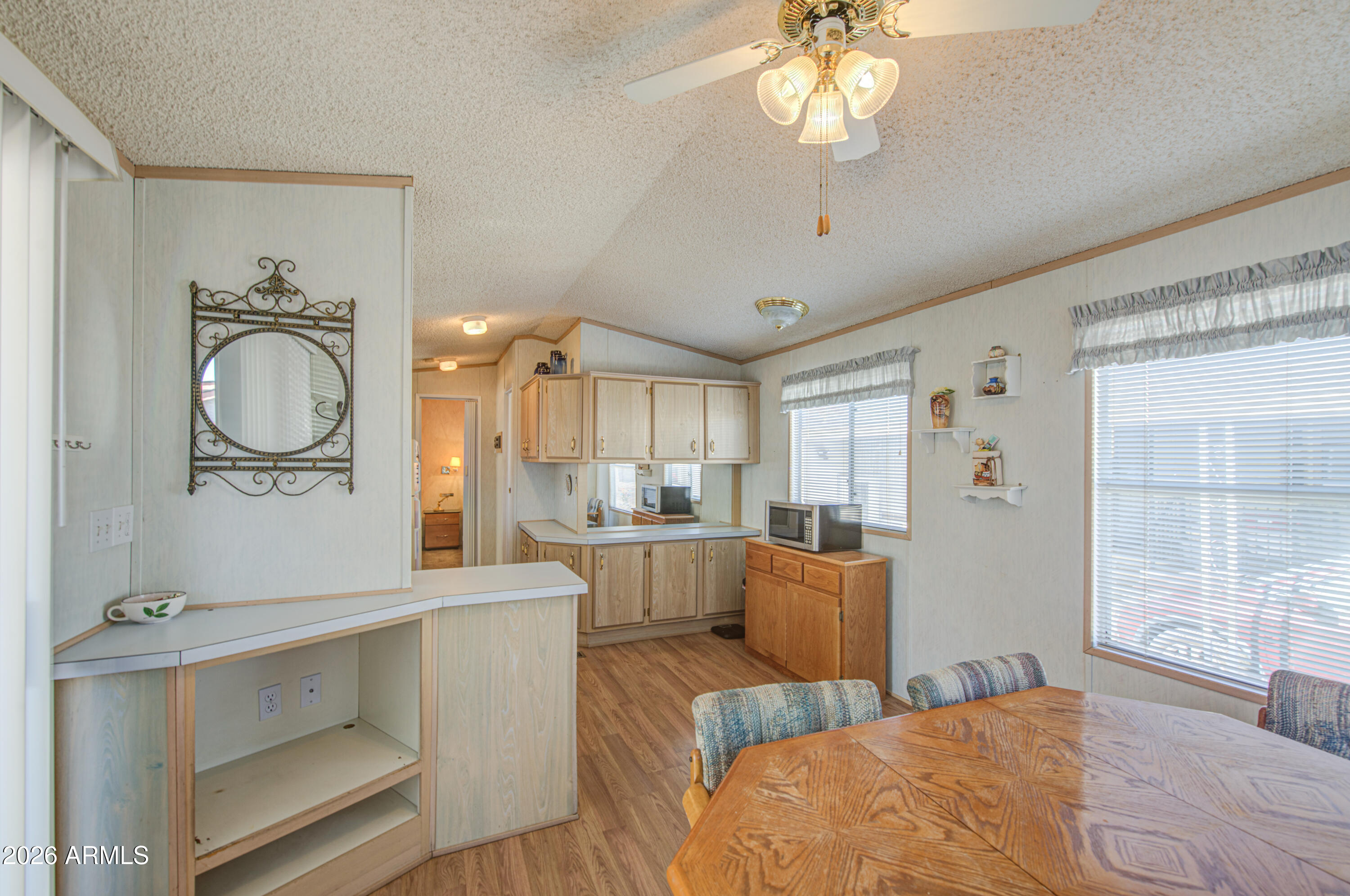 7750 East Broadway Road, Unit 273 Mesa, AZ 85208 - Photo 10 of 36 a bedroom with furniture a chandelier and a window