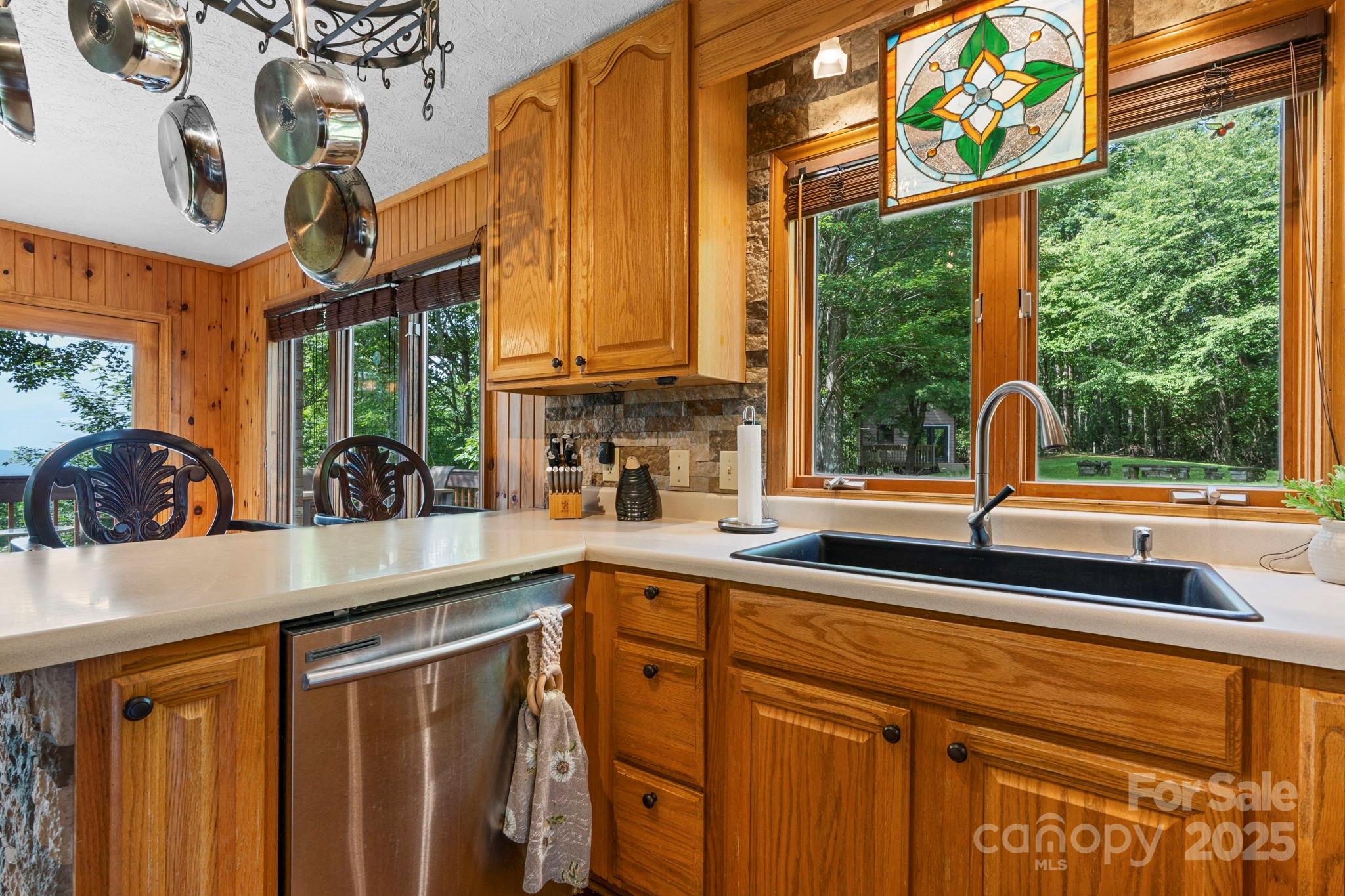 4415 Laurel Ridge Drive Lenoir, NC 28645 - Photo 11 of 48 a kitchen with stainless steel appliances granite countertop a sink and a large window