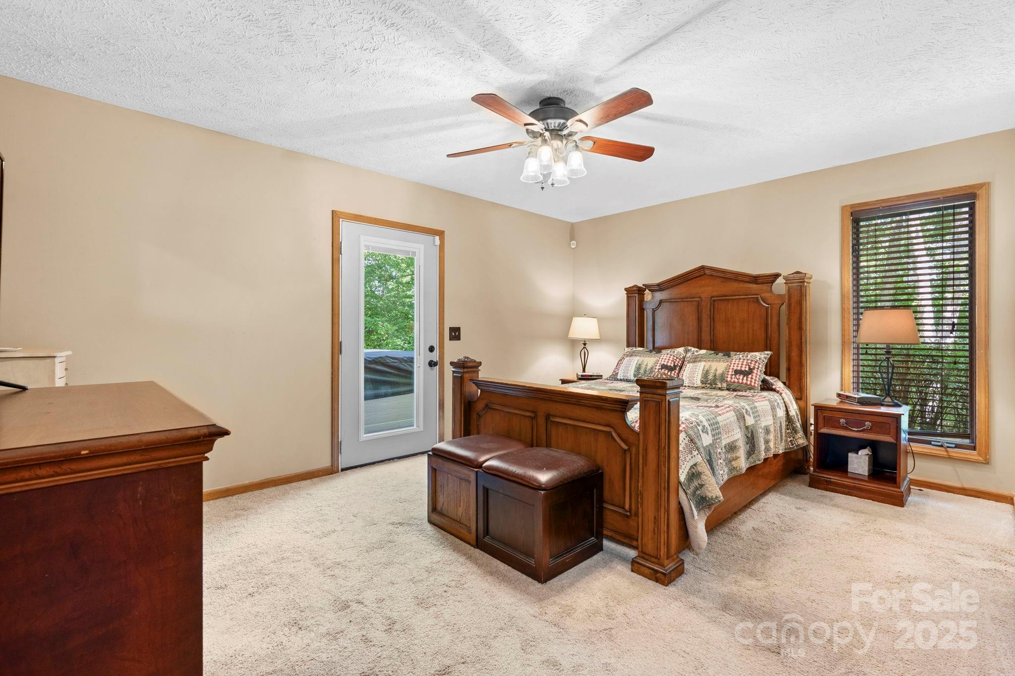 4415 Laurel Ridge Drive Lenoir, NC 28645 - Photo 16 of 48 a bedroom with a bed and a chandelier