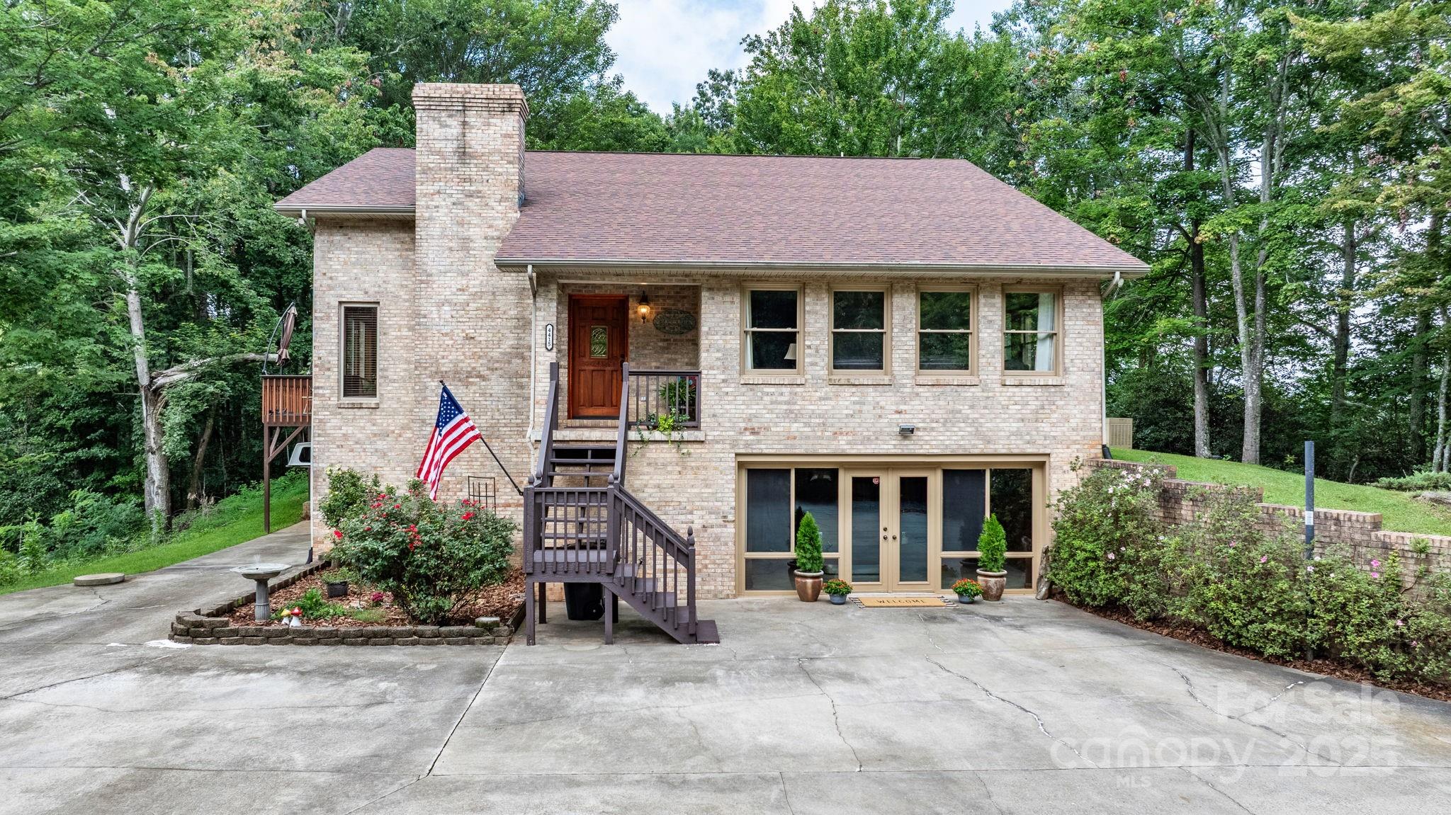 4415 Laurel Ridge Drive Lenoir, NC 28645 - Photo 2 of 48 a front view of a house with a yard and garage