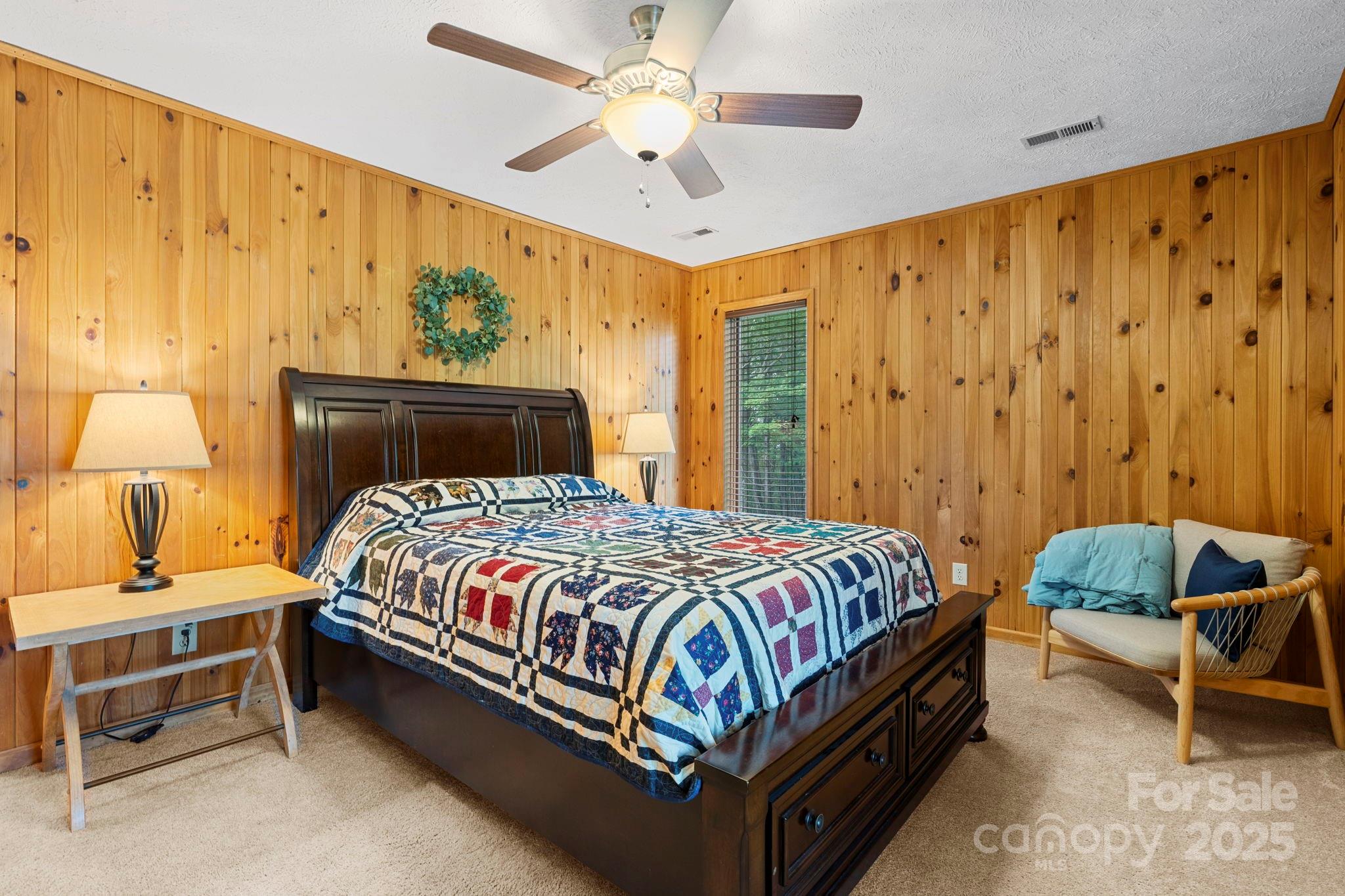4415 Laurel Ridge Drive Lenoir, NC 28645 - Photo 23 of 48 a bedroom with a bed and a chandelier