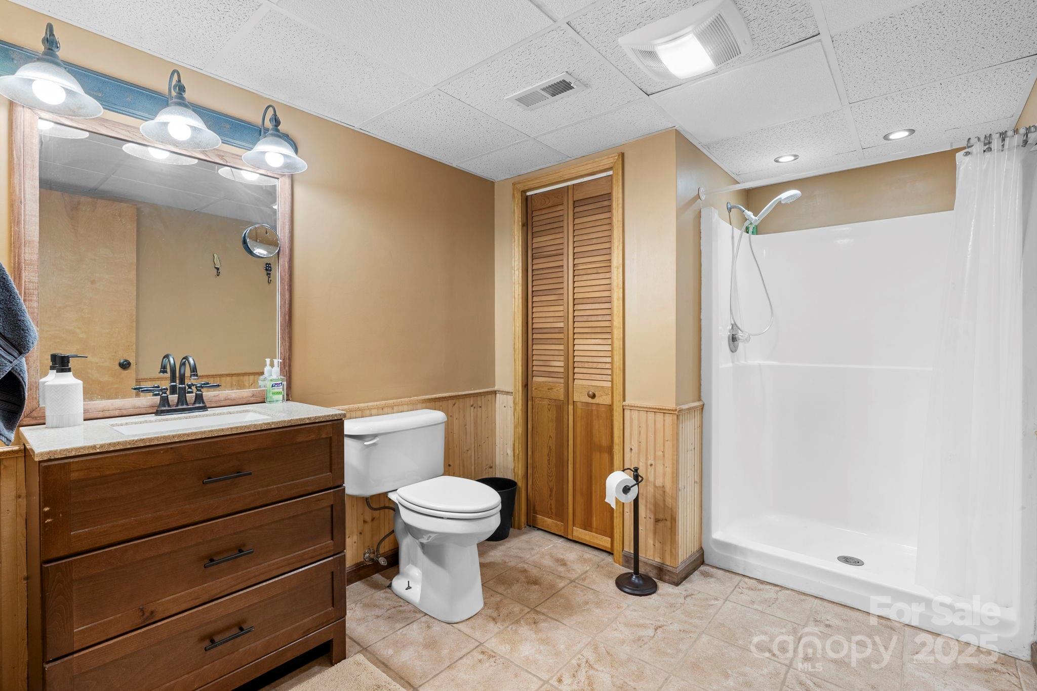 4415 Laurel Ridge Drive Lenoir, NC 28645 - Photo 28 of 48 a bathroom with a granite countertop sink mirror vanity and toilet