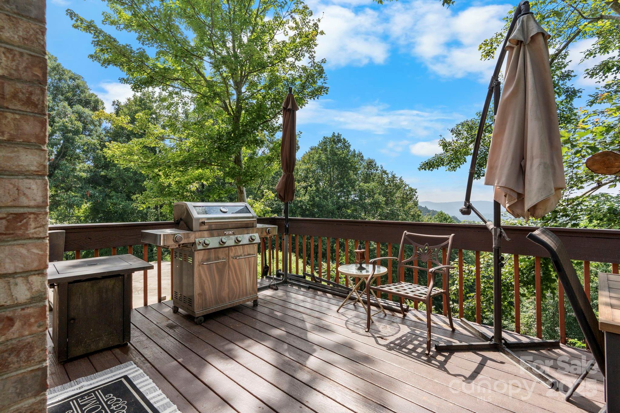 4415 Laurel Ridge Drive Lenoir, NC 28645 - Photo 30 of 48 a view of a chairs and table on the wooden roof deck