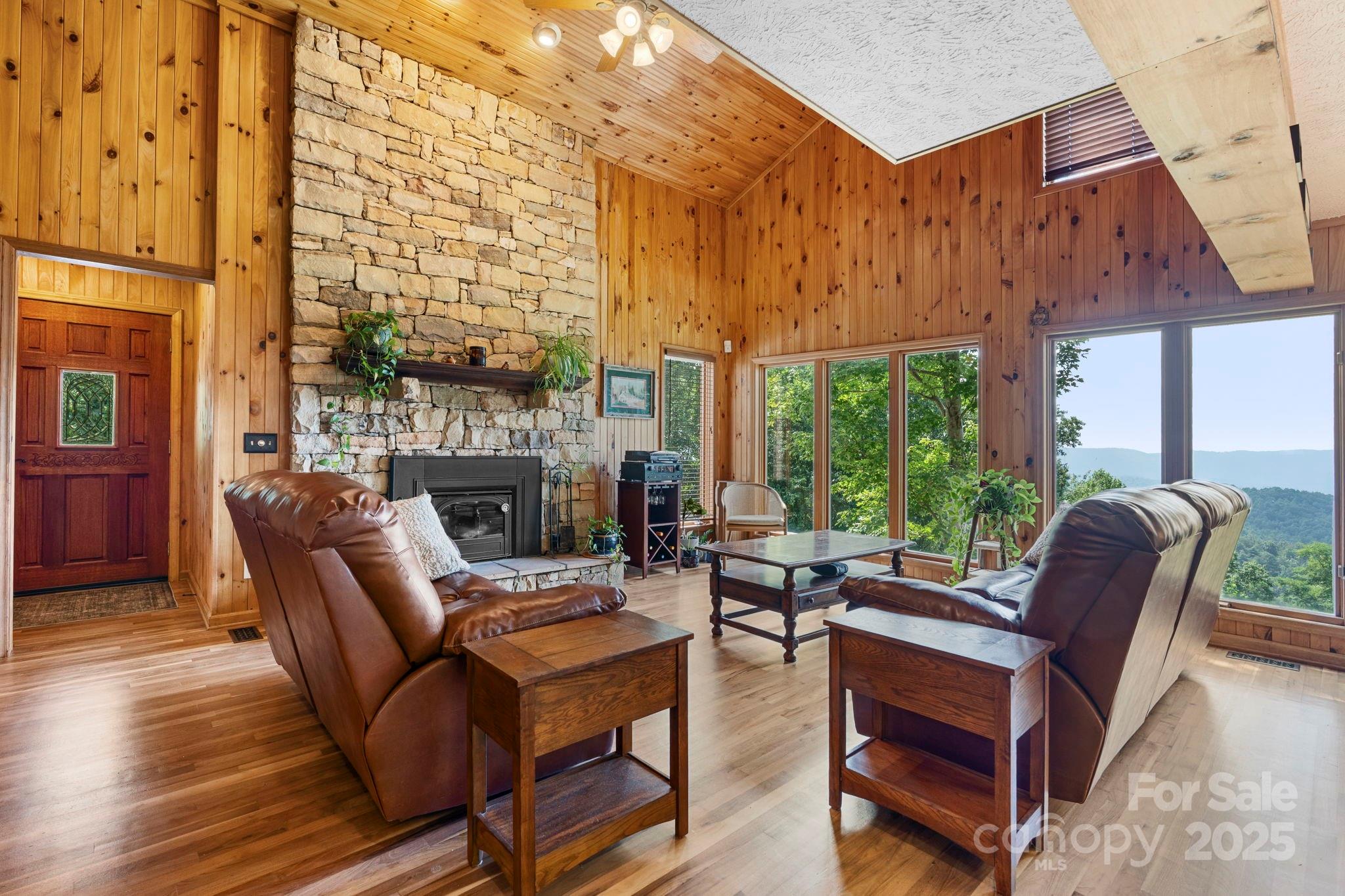 4415 Laurel Ridge Drive Lenoir, NC 28645 - Photo 4 of 48 a living room with furniture a large window and a fireplace
