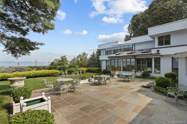 a view of a patio with table and chairs and potted plants
