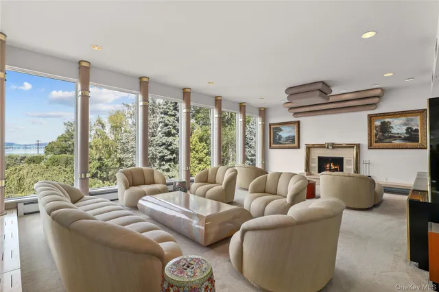 a living room with furniture large window and fireplace