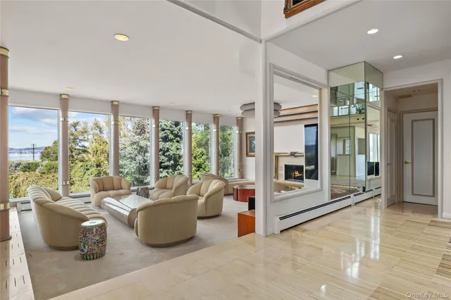 a living room with furniture and large windows