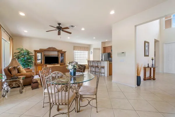 a kitchen with granite countertop a refrigerator stove microwave and sink