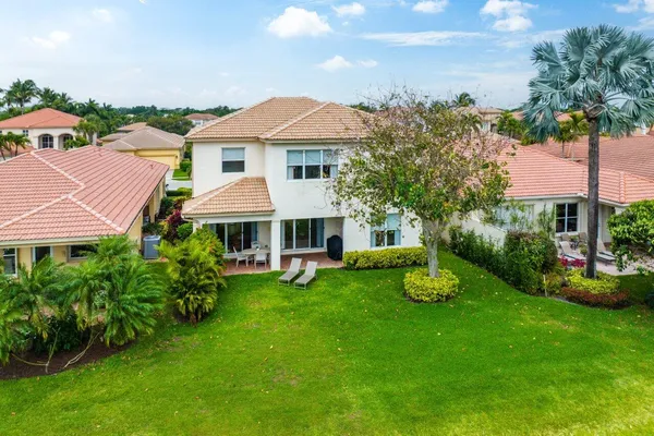 an aerial view of residential houses with outdoor space and swimming pool